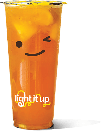 A clear plastic cup filled with iced tea and fruit pieces, featuring a winking smiley face and the words "light it up" printed on the front.