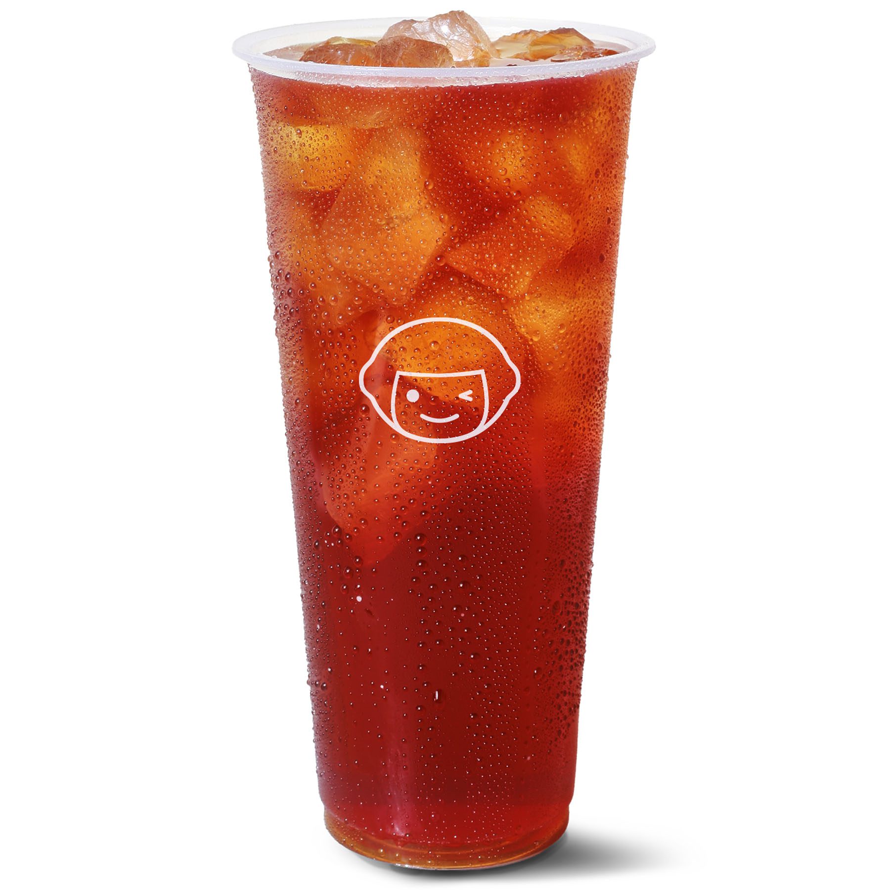 A large clear plastic cup filled with iced tea and ice cubes, with condensation on the outside and a white outline of a smiling face logo on the front.