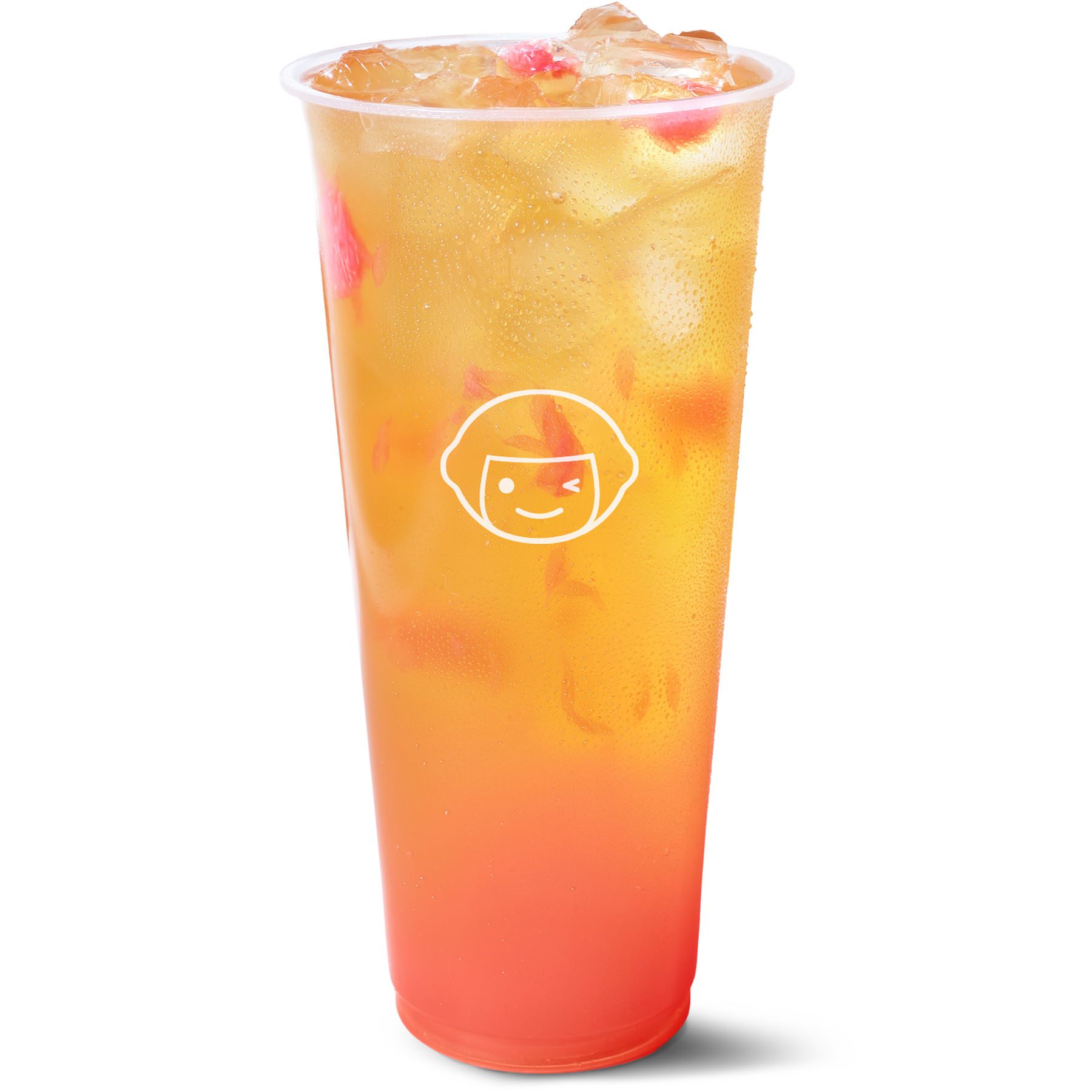 A tall, clear plastic cup filled with an orange and red gradient iced drink, topped with ice cubes. The cup features a simple cartoon face logo on the front.