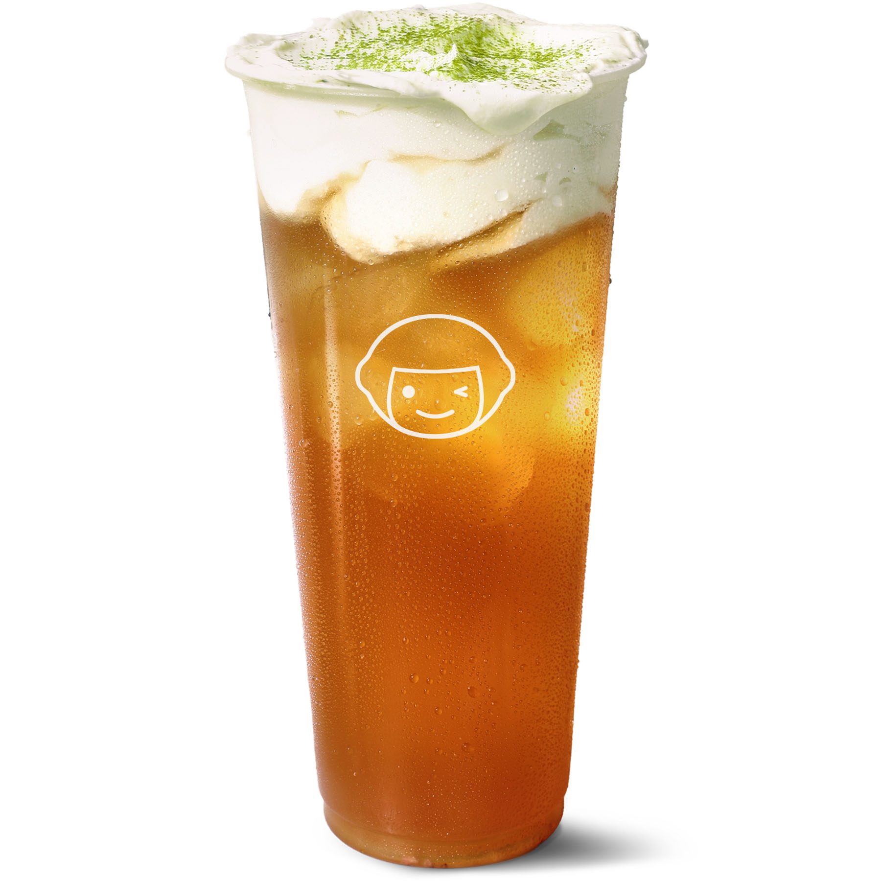 A tall, clear plastic cup filled with iced tea and topped with a thick layer of cream and a sprinkling of green powder, featuring a simple smiling face logo on the front.
