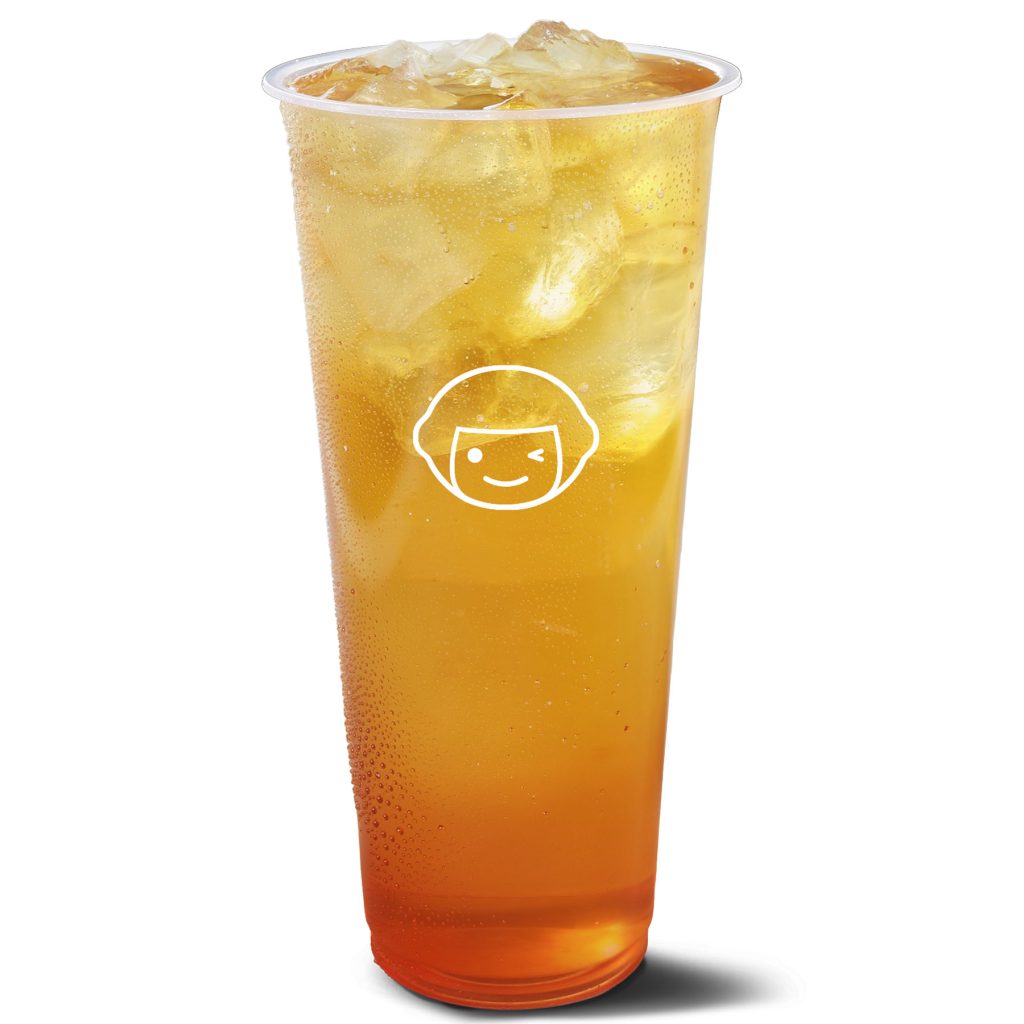 A clear plastic cup filled with iced tea and ice cubes, with condensation on the outside and a simple white cartoon face logo on the front.